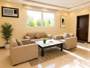 a living room with two couches and a coffee table at سويت tolan in Hail