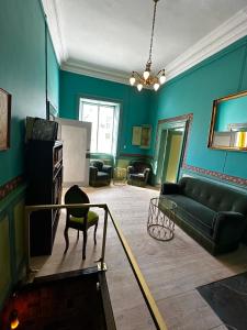 a living room with blue walls and a couch at Estrup Hovedgaard in Vejen
