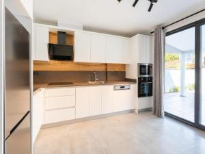 a kitchen with white cabinets and a large window at Villa Exclusive Paradise 2 in Dalyan