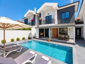 a villa with a swimming pool and a house at Villa Exclusive Paradise 2 in Dalyan