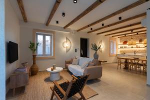 a living room with a couch and a table at Olea Stone Villa in Pylos
