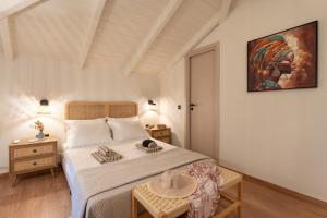 a bedroom with a large bed and a table at Olea Stone Villa in Pylos +27 photos