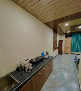 a kitchen with a counter and a stove top oven at Nimat Nivas By Fuwa Homestay in Vashisht
