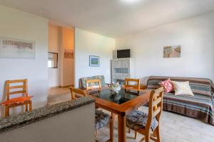 a living room with a table and a couch at Appartamenti Abbaidda 4 in Valledoria