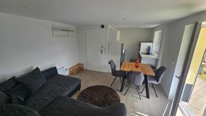 a living room with a couch and a table at Schwarzwald Lodge Schonach in Schonach