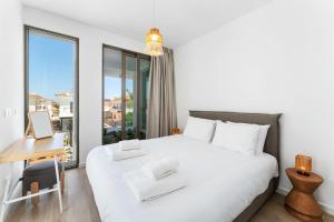 a bedroom with a bed and a desk and a window at PANKI Beach Villa Protaras in Protaras
