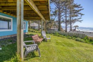 two chairs sitting on the grass next to a house at Serendipity -A Happy Surprise Unit B in Oceanside +18 photos