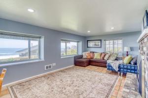 a living room with a couch and two windows at Serendipity -A Happy Surprise Unit B in Oceanside