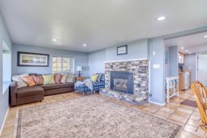 a living room with a couch and a fireplace at Serendipity -A Happy Surprise Unit B in Oceanside