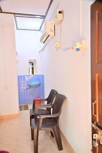 a chair in a room with a sink at SUN SHINE RESORT in Neil Island