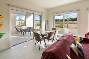 a living room with a couch and a table at The Icon 001 - Superior 2BR Apartment with Pool & Gym, Mythical Seas - Protaras in Paralimni