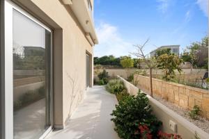 an external view of a garden from a house at The Icon 001 - Superior 2BR Apartment with Pool & Gym, Mythical Seas - Protaras in Paralimni