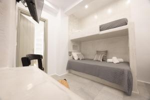 a bedroom with a bed in a white room at Ione Inn in Naxos Chora