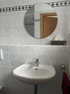 a bathroom with a sink and a mirror at PusteBlume in Bückeburg +7 photos