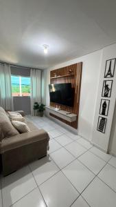 a living room with a couch and a flat screen tv at 1- Apartamento aconchegante 1200m do Centro in Serra Talhada +5 photos