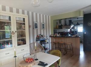 a living room with a table and a kitchen at Eugenie86 chbre2 in Poitiers