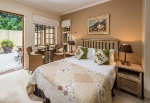 a bedroom with a large bed and a patio at Algoa Guest House Summerstrand in Port Elizabeth +25 photos