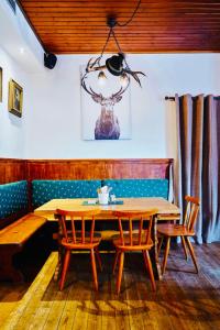 a table in a restaurant with chairs and a chandelier at rooms11 in Salzburg
