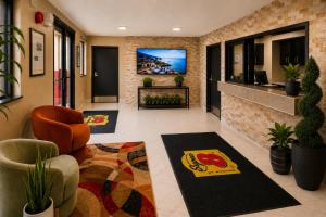 a lobby with a waiting room with a tv on the wall at Super 8 by Wyndham Lexington Park/California Area in California