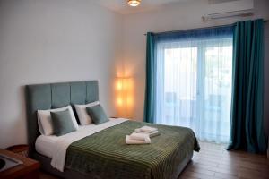 a bedroom with a bed with two towels on it at Soultana’s house in Mourteri