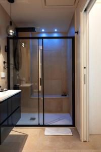 a bathroom with a glass shower with a tub at Sunset Beach Club Tropea in Tropea +37 photos