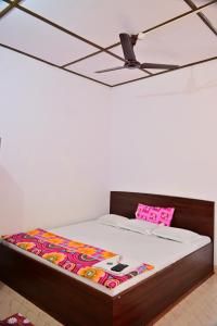 a bed in a room with a pink and white mattress at SUN SHINE RESORT in Neil Island