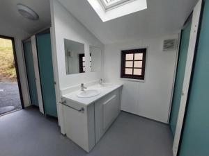 a bathroom with a sink and a mirror at Cwm Clyd - Carthouse in Rhayader