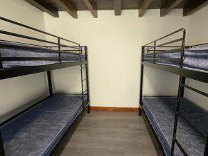 a room with three bunk beds in it at Cwm Clyd - Carthouse in Rhayader