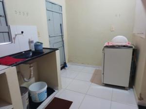 a kitchen with a sink and a small refrigerator at Casa de Lagoa Nova in Martins