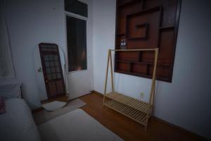 a living room with a staircase and a room with a door at Pawseas Homestay in Danang