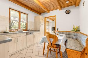 a kitchen with a table and chairs and a couch at Mayerbauer in Piding