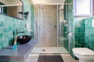 a bathroom with a shower with a sink and a toilet at Walk to Fly Gate 65 Appartaments in Naples +12 photos