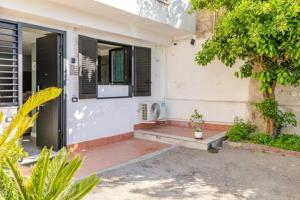 a house with a porch with a window and a bench at Walk to Fly Gate 65 Appartaments in Naples