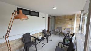 a room with chairs and a table and a lamp at Naiot Hotel Boutique in Medellín