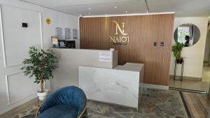 a lobby with a waiting area with aania sign on the wall at Naiot Hotel Boutique in Medellín