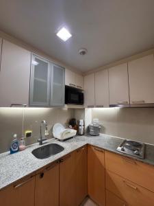 a kitchen with a sink and a counter top at Luxe Gold Mactan in Mactan