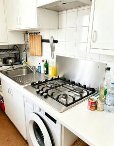 a kitchen with a stove and a sink at Private Room Pré-Saint-Gervais in Le Pré-Saint-Gervais