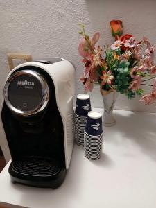 a toaster sitting on a table with a vase of flowers at Ada's guest house in Bosa