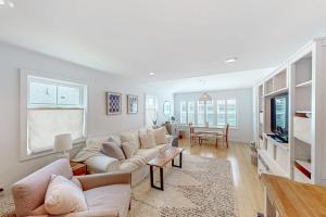 a living room with a couch and a table at Yellow Door Cottage in Meredith