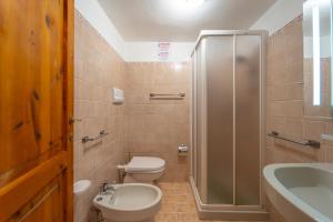 a bathroom with a toilet and a shower and a sink at Mury by DomusAway in Porto Istana +9 photos