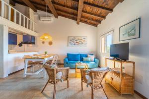 a living room with a blue couch and a table at Mury by DomusAway in Porto Istana