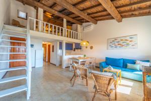 a living room with a blue couch and a table at Mury by DomusAway in Porto Istana