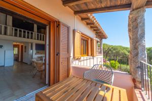a balcony with a bench on a house at Mury by DomusAway in Porto Istana