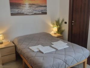 a bedroom with a bed with two towels on it at Red Rose Tiburtina in Rome