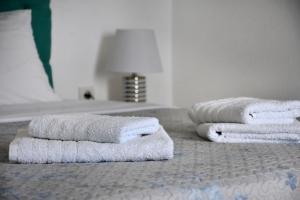 a pile of towels sitting on top of a bed at Soultana’s house in Mourteri +54 photos