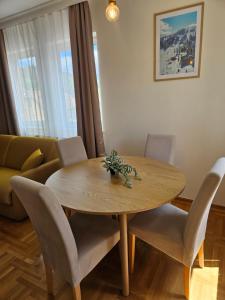 a wooden table and chairs in a living room at Velike Šume Apartment in Pale