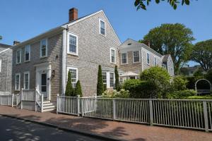 a white fence in front of a house at 29 India House in Nantucket