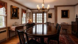a dining room with a large wooden table and chairs at 29 India House in Nantucket