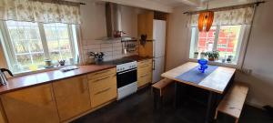 a kitchen with a counter and a table in it at Lægran Gård in Steinkjer +18 photos