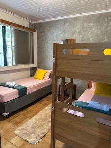 a bedroom with two bunk beds and a mirror at Hostel Lunar in Alto Paraíso de Goiás